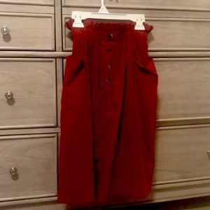 Red skirt with brown bottons. Only worn afew times.